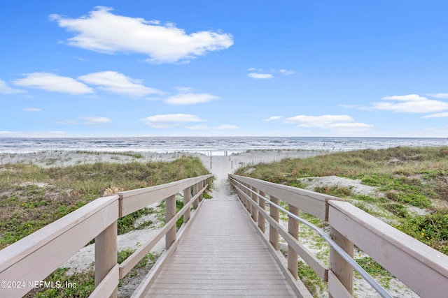 view of home's community featuring a water view and a view of the beach