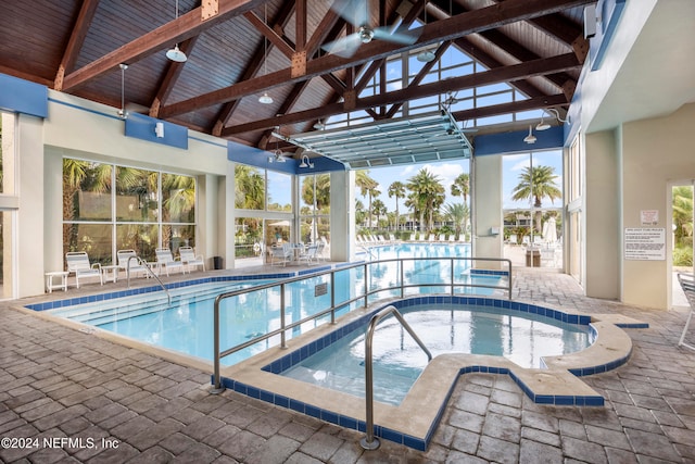 view of swimming pool with a patio area and an indoor in ground hot tub