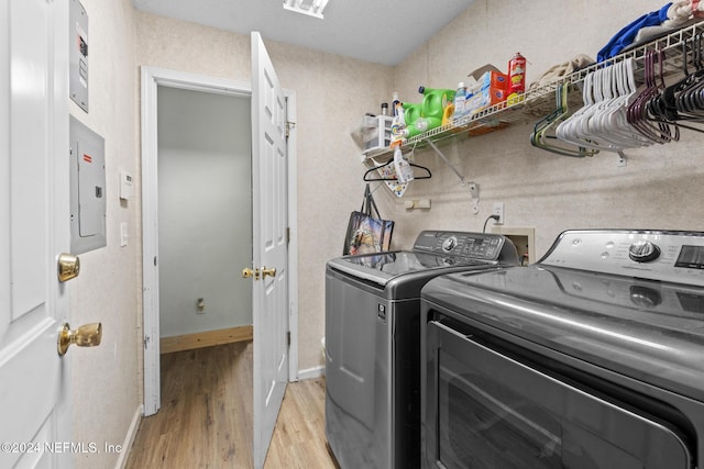 978 Tammy Cove Ln, Jacksonville, FL 32218 - laundry room with laundry area, light wood-style floors, baseboards, electric panel, and separate washer and dryer