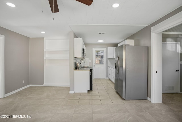 3730 Abby Ln, Jacksonville, FL 32207 - kitchen with white cabinets, appliances with stainless steel finishes, tasteful backsplash, and light tile patterned flooring