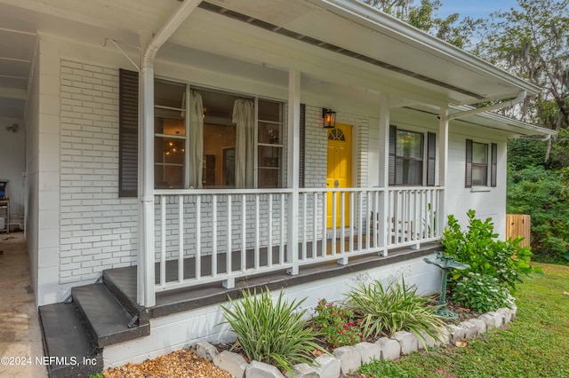 view of exterior entry featuring a porch