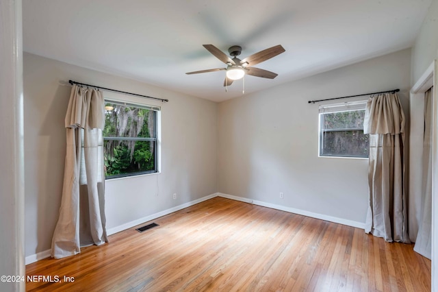 spare room featuring ceiling fan and hardwood / wood-style floors