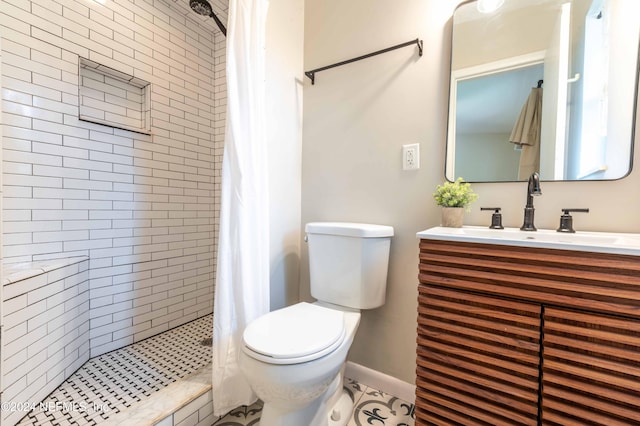 bathroom featuring toilet, vanity, tile patterned floors, and a shower with shower curtain