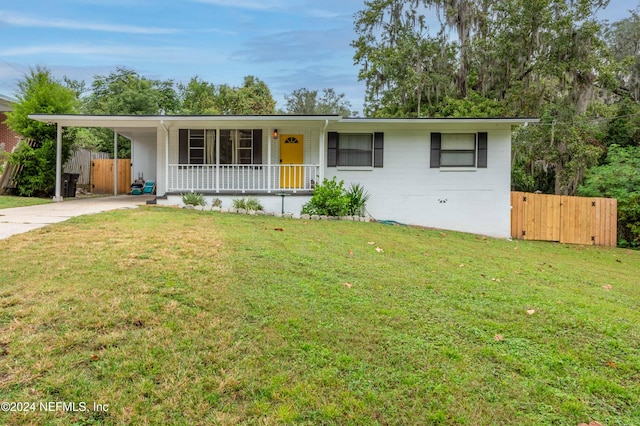 ranch-style house with a carport, a front lawn, and a porch