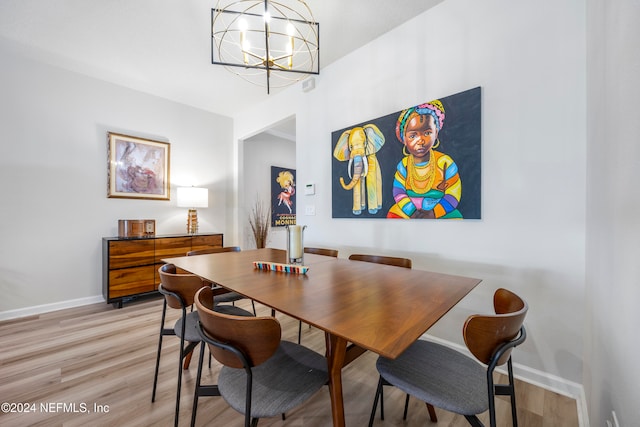 dining space featuring light hardwood / wood-style flooring and a notable chandelier