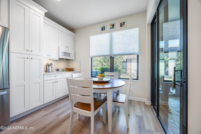 dining area with light hardwood / wood-style flooring