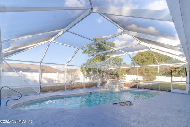 view of pool with pool water feature, a lanai, and a patio