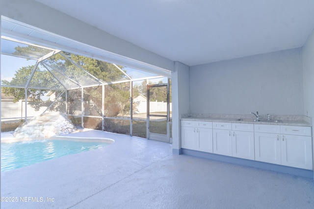 view of swimming pool featuring pool water feature and sink