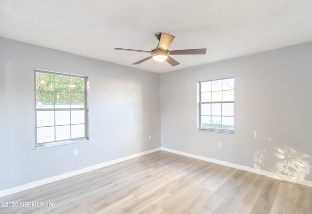 unfurnished room featuring a textured ceiling, light hardwood / wood-style floors, ceiling fan, and a healthy amount of sunlight