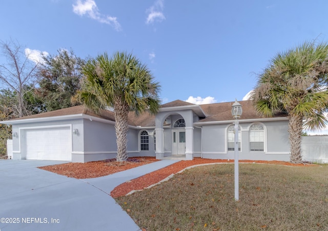 view of front facade with a front lawn and a garage