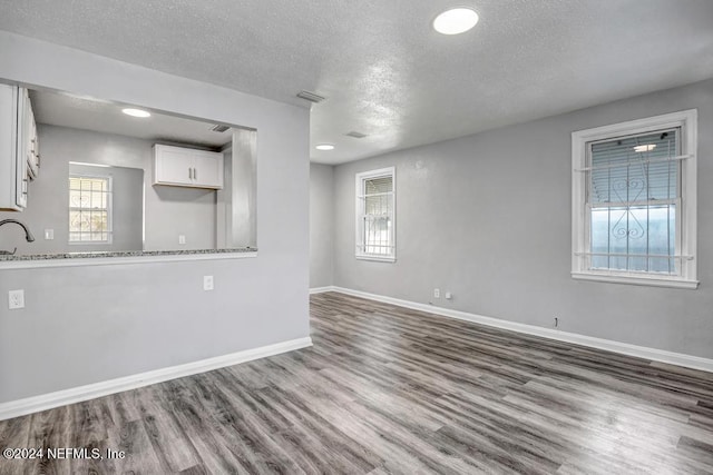 interior space with hardwood / wood-style floors and a textured ceiling