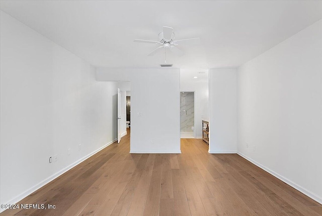 empty room with light wood-type flooring and ceiling fan