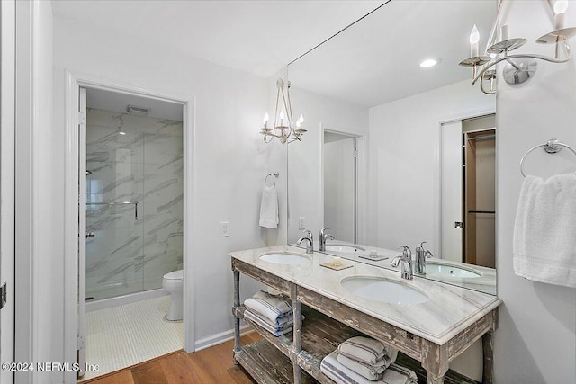 bathroom with vanity, toilet, a shower with shower door, and hardwood / wood-style floors