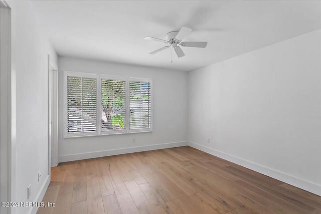 unfurnished room featuring light wood-type flooring and ceiling fan