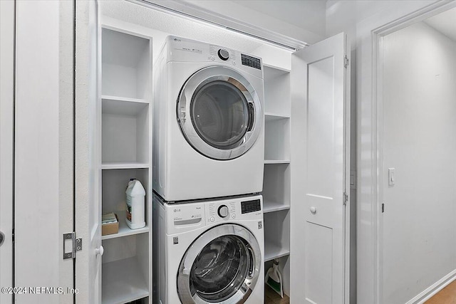 laundry room with stacked washer / drying machine