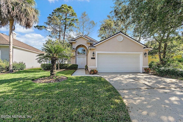 view of front facade with a garage and a front lawn