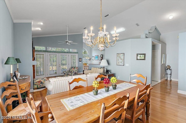 dining space featuring ceiling fan with notable chandelier, light hardwood / wood-style flooring, ornamental molding, and french doors