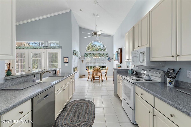 kitchen featuring white appliances, ceiling fan, sink, high vaulted ceiling, and light tile patterned floors