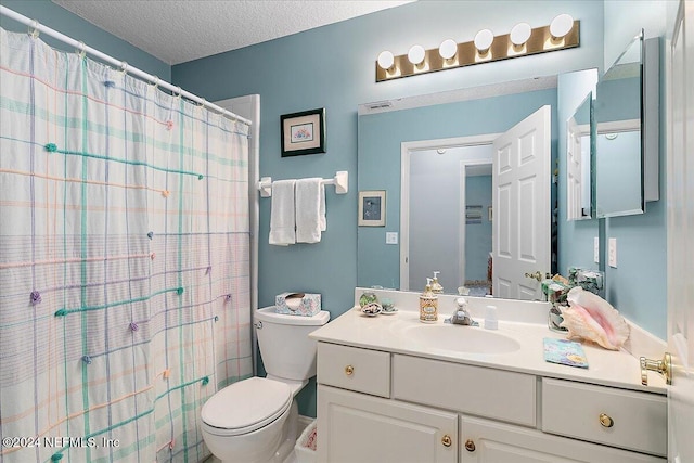 bathroom featuring toilet, vanity, a textured ceiling, and curtained shower