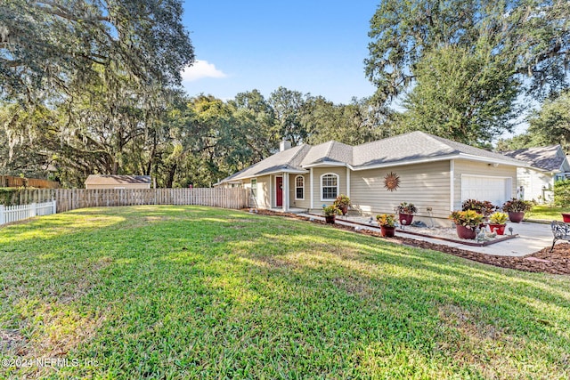 single story home featuring a front lawn and a garage