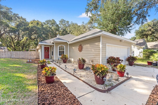 single story home with a front lawn and a garage