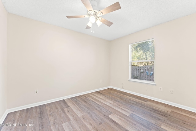 unfurnished room featuring light hardwood / wood-style floors, a textured ceiling, and ceiling fan