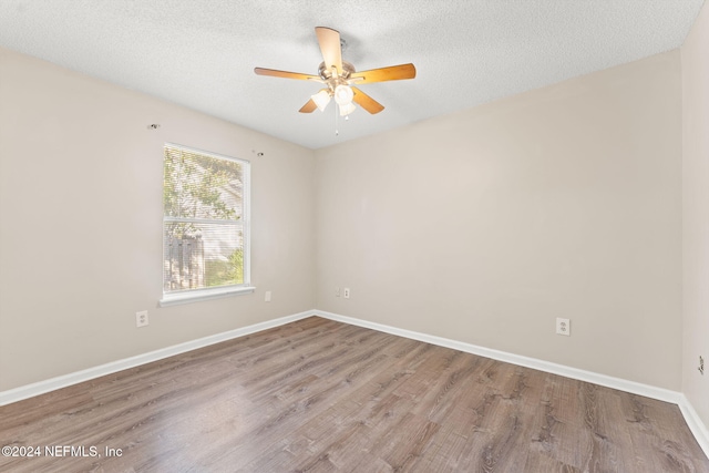 unfurnished room with hardwood / wood-style floors, a textured ceiling, and ceiling fan