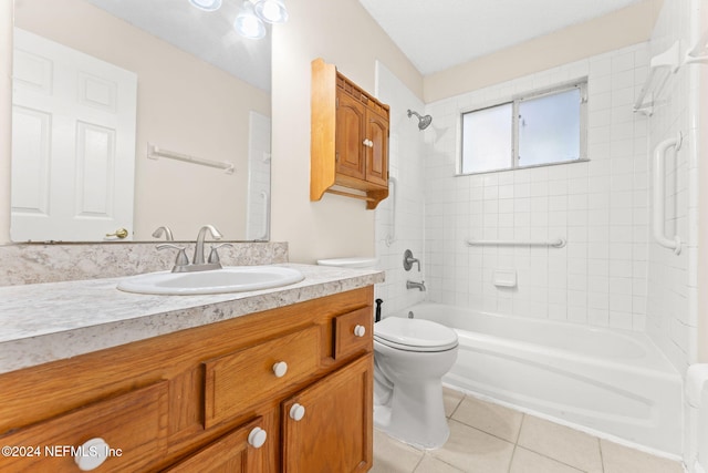 full bathroom with tiled shower / bath, vanity, toilet, and tile patterned floors