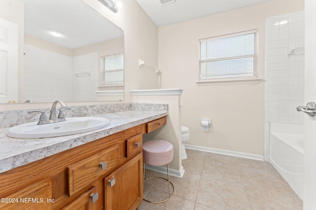 full bathroom featuring a textured ceiling, toilet, vanity, tiled shower / bath combo, and tile patterned flooring