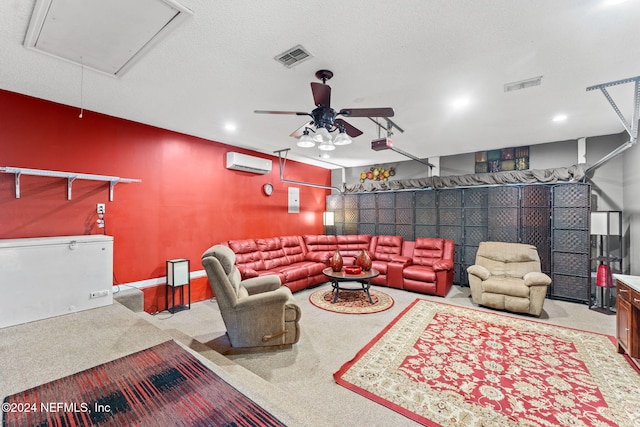 carpeted cinema with ceiling fan, an AC wall unit, and a textured ceiling