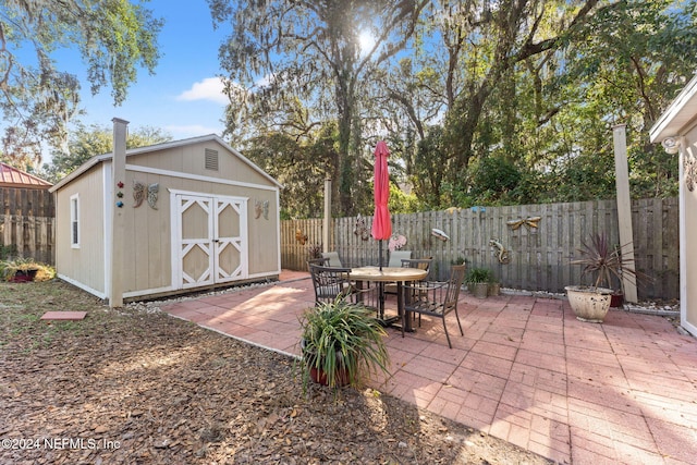 view of patio with a storage unit