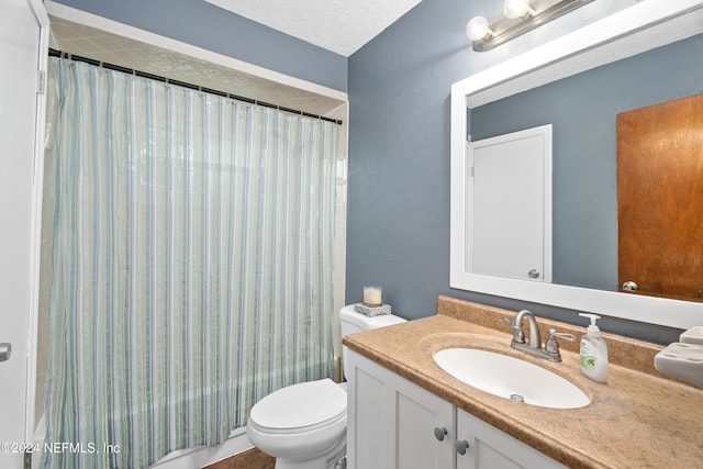 full bathroom with vanity, toilet, a textured ceiling, and shower / bath combo