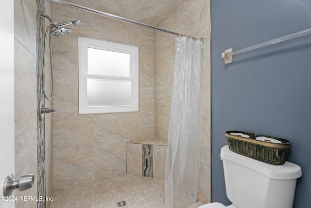 bathroom featuring curtained shower and toilet