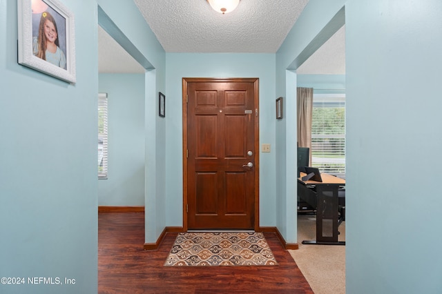 entrance foyer featuring a textured ceiling and hardwood / wood-style flooring