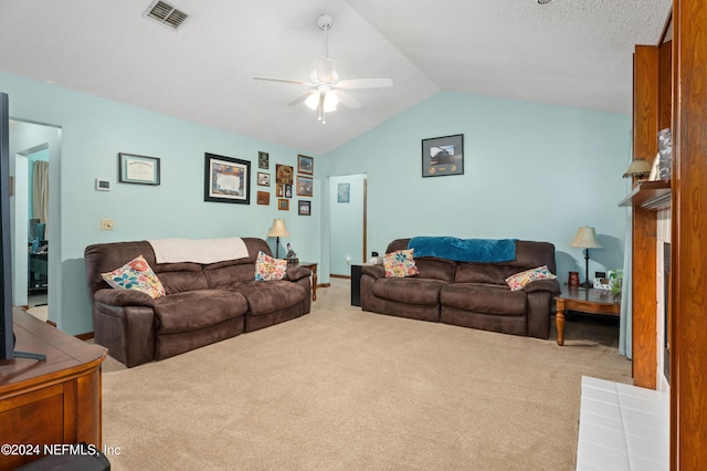 living room with ceiling fan, carpet flooring, and vaulted ceiling