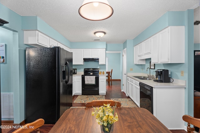 kitchen featuring sink, black appliances, white cabinetry, and hardwood / wood-style flooring