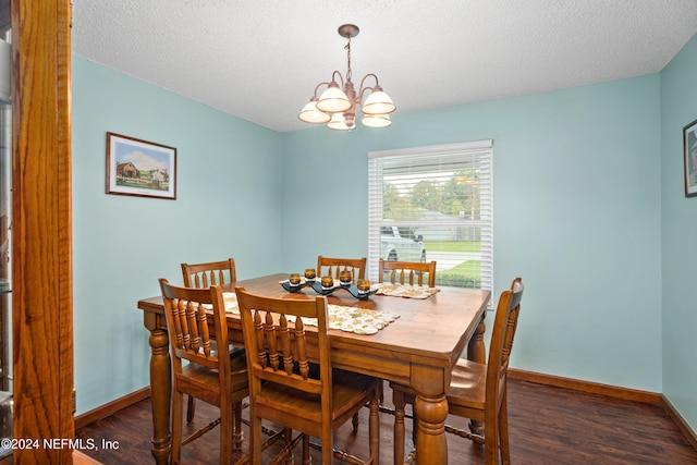 dining space featuring a notable chandelier, a textured ceiling, and dark hardwood / wood-style flooring