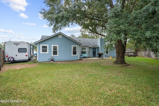 back of property featuring a yard and a patio area