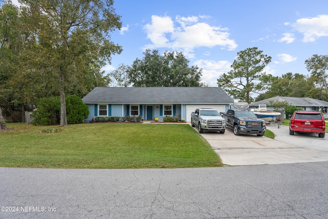 view of front of house featuring a garage and a front lawn