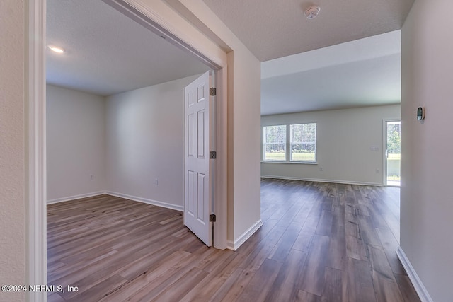 corridor featuring light hardwood / wood-style floors and a textured ceiling