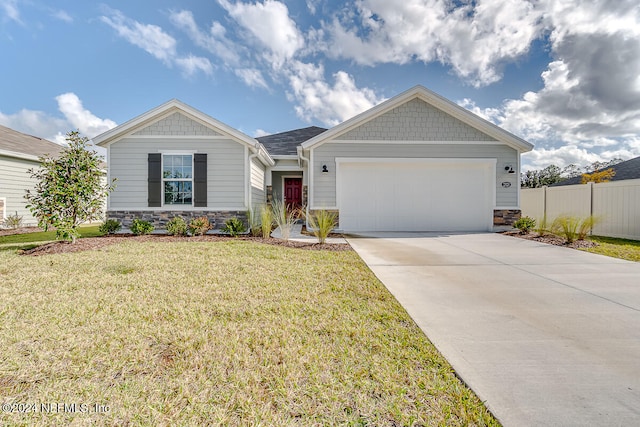 view of front of property featuring a garage and a front lawn