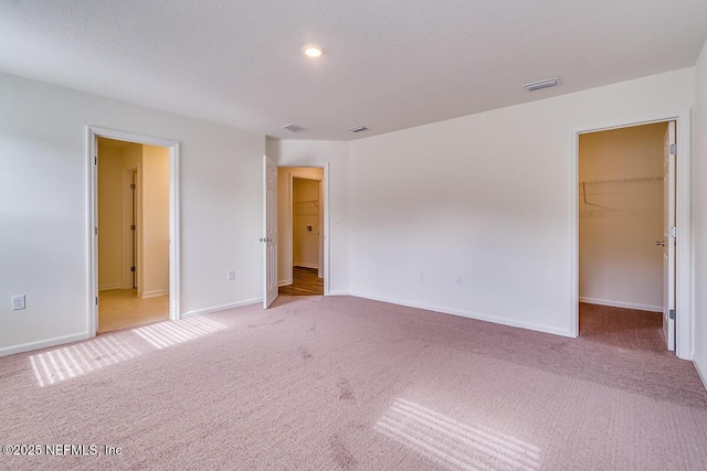 2320 Dallas Creek Ln, Green Cove Springs, FL 32043 - unfurnished bedroom with light carpet, a spacious closet, baseboards, and recessed lighting
