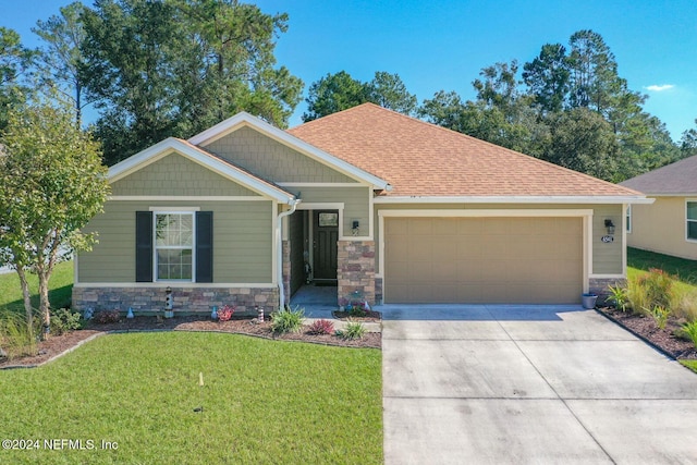 craftsman inspired home featuring a front lawn and a garage