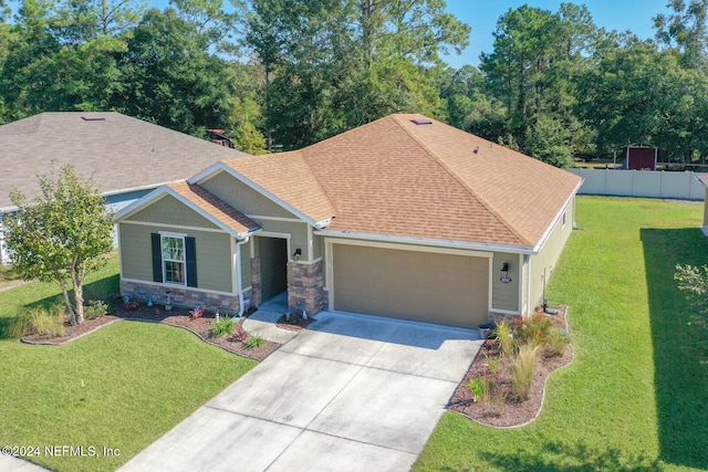 view of front of home featuring a front yard and a garage