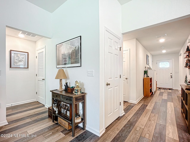 corridor with hardwood / wood-style flooring