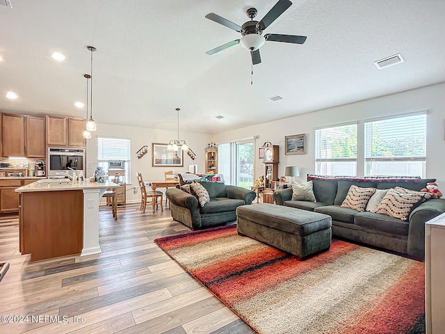 living room featuring light hardwood / wood-style flooring and ceiling fan