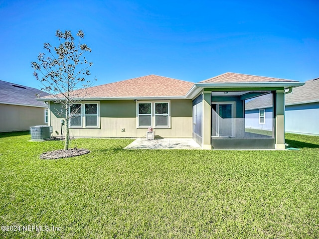 rear view of property featuring a patio area, a yard, and cooling unit