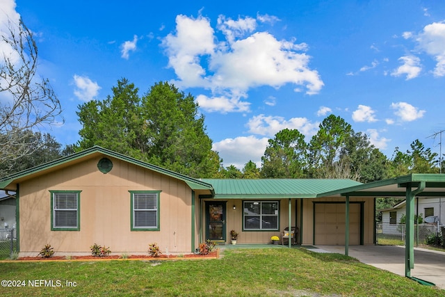 ranch-style home featuring a front lawn and a garage