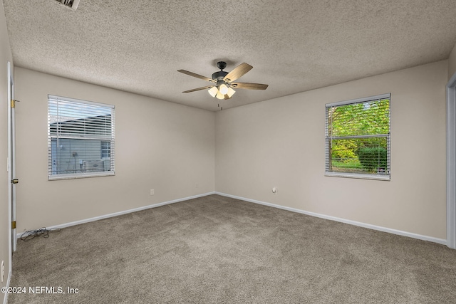 carpeted spare room with ceiling fan and a textured ceiling