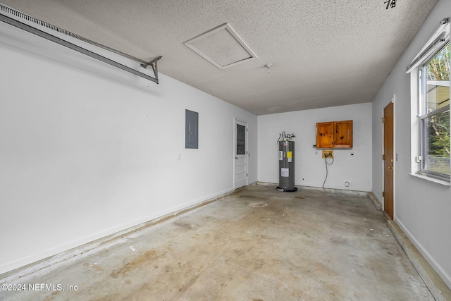 garage featuring electric panel and water heater